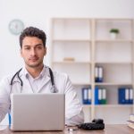 Internist reviewing patient records and medical billing documentation for accurate reimbursement