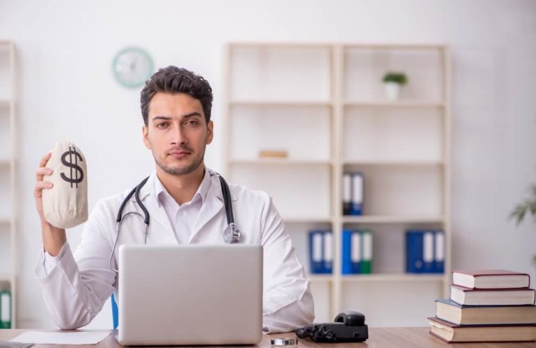 Internist reviewing patient records and medical billing documentation for accurate reimbursement