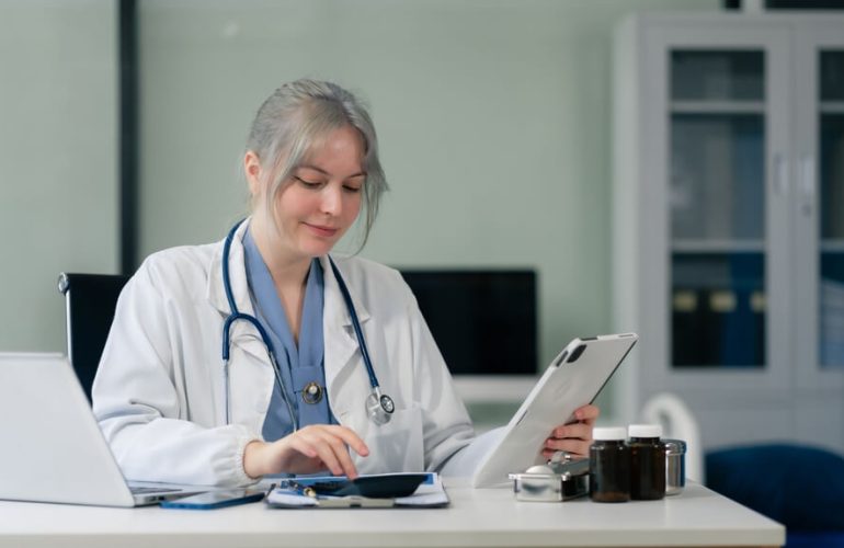 Healthcare billing specialist reviewing insurance payments and EOB during payment posting process